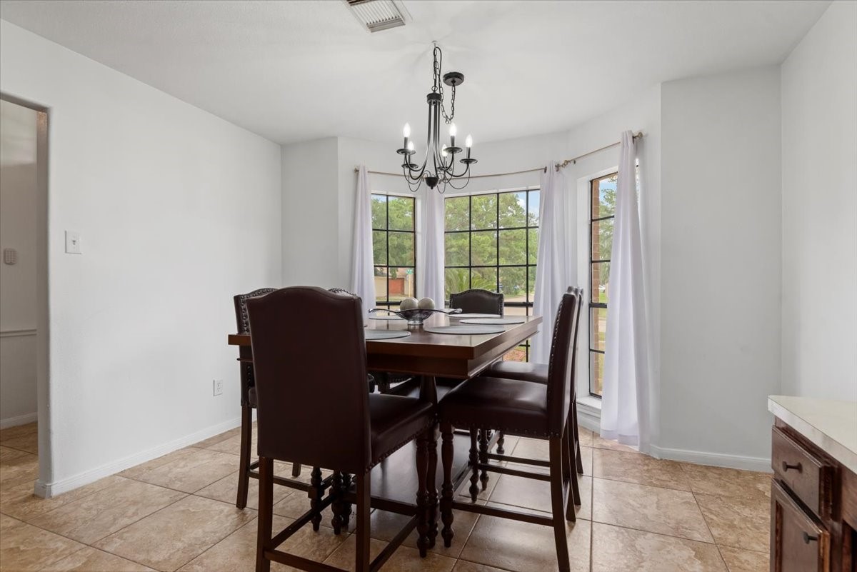 22711 Tree House Lane Spring, TX 77373 - Photo 15 of 28 a view of a dining room with furniture window and outside view