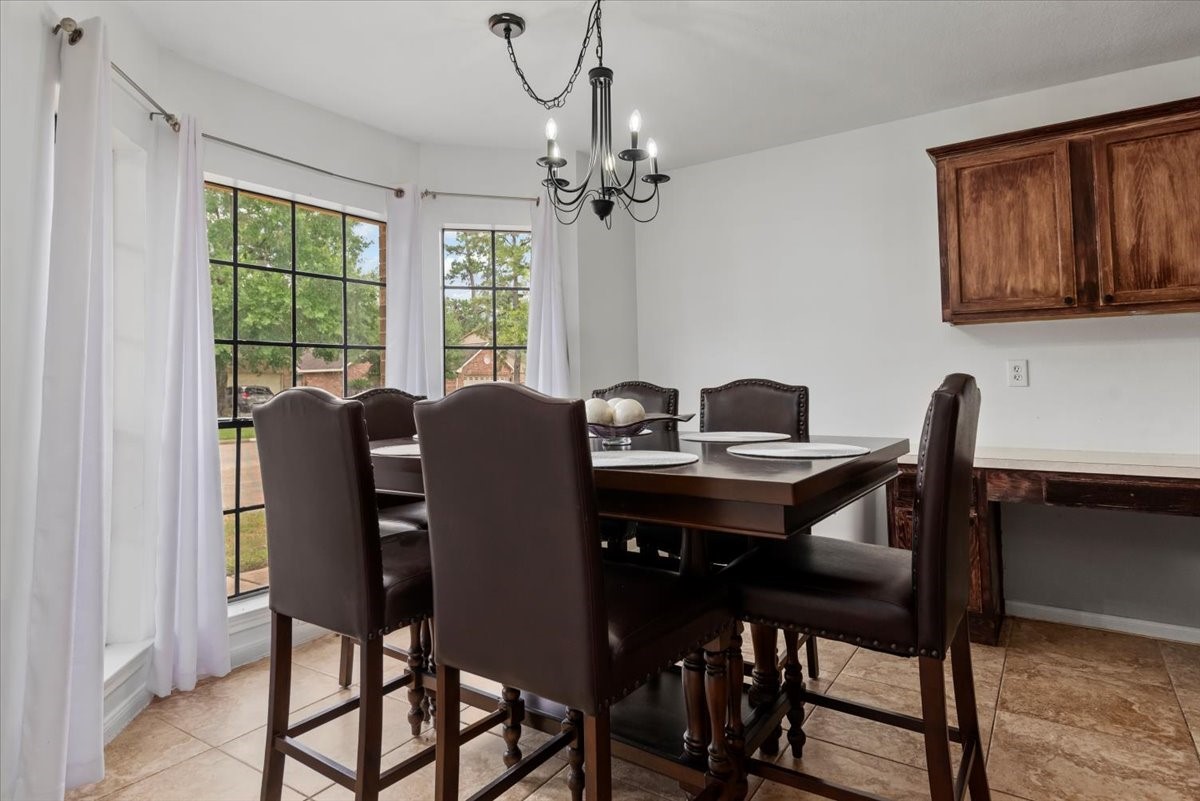 22711 Tree House Lane Spring, TX 77373 - Photo 16 of 28 a view of a dining room with furniture window and outside view