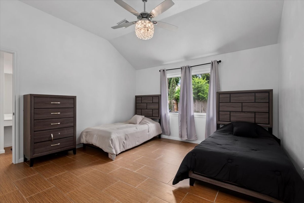 22711 Tree House Lane Spring, TX 77373 - Photo 17 of 28 a bedroom with a bed dresser and a window
