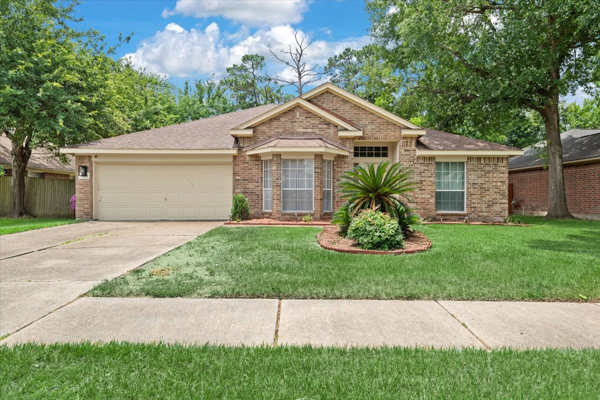 22711 Tree House Lane Spring, TX 77373 - Photo 2 of 28 a view of a house with a yard and large tree