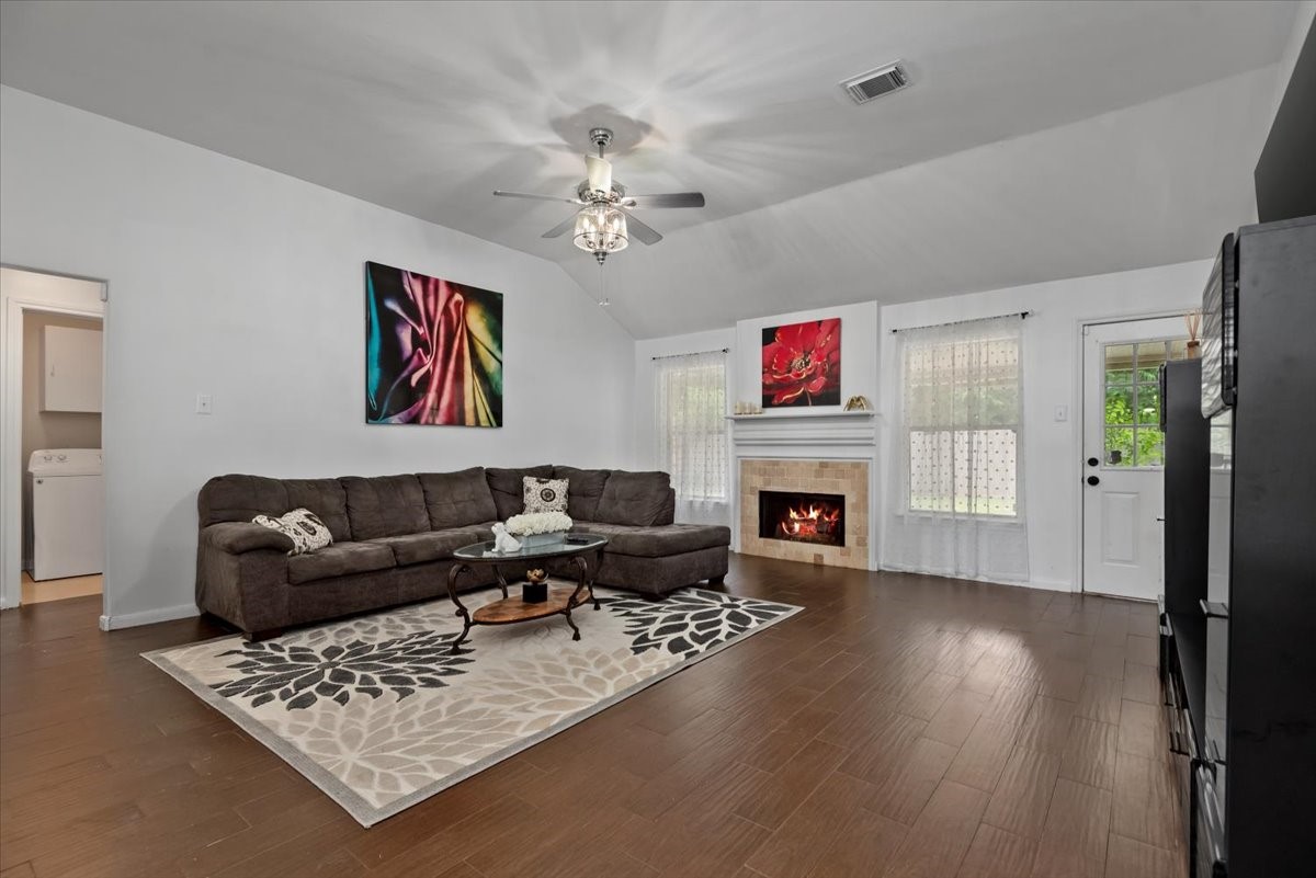22711 Tree House Lane Spring, TX 77373 - Photo 7 of 28 a living room with furniture a fireplace and wooden floor