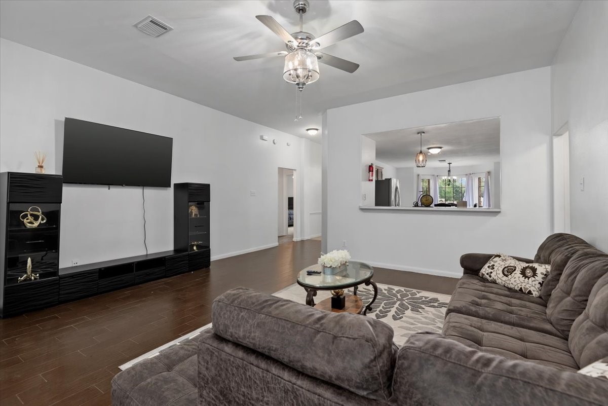 22711 Tree House Lane Spring, TX 77373 - Photo 9 of 28 a living room with furniture and a flat screen tv