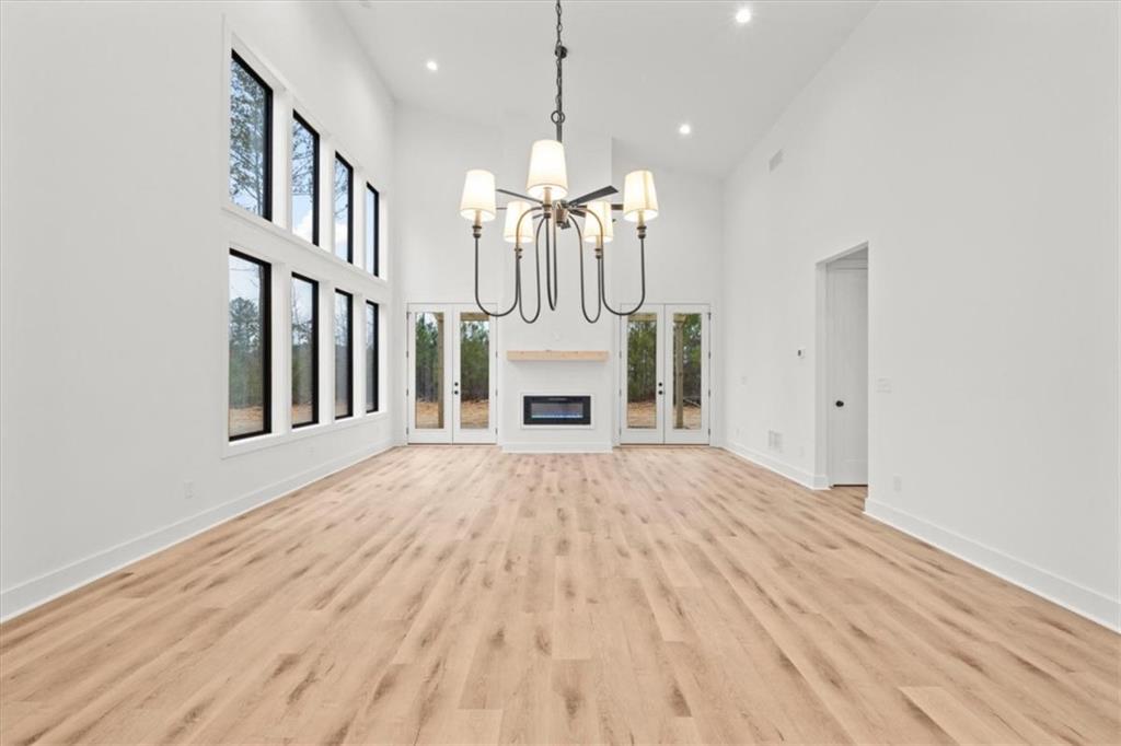 419 Lively Road Waco, GA 30182 - Photo 13 of 48 a view of an empty room with chandelier fireplace and a window