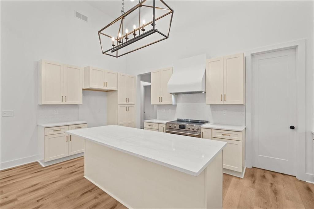 419 Lively Road Waco, GA 30182 - Photo 22 of 48 a kitchen with stainless steel appliances white cabinets and wooden floor