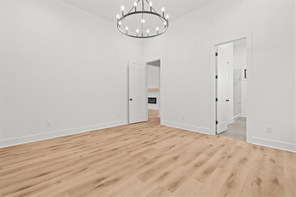 419 Lively Road Waco, GA 30182 - Photo 23 of 48 a view of an empty room with wooden floor and a window