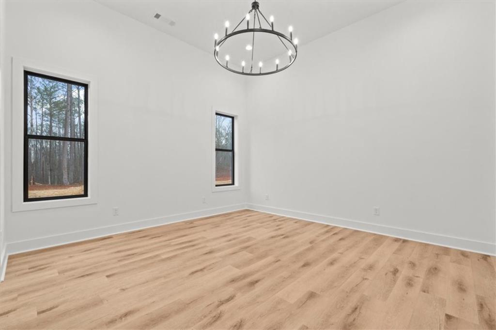 419 Lively Road Waco, GA 30182 - Photo 24 of 48 a view of empty room with wooden floor and window
