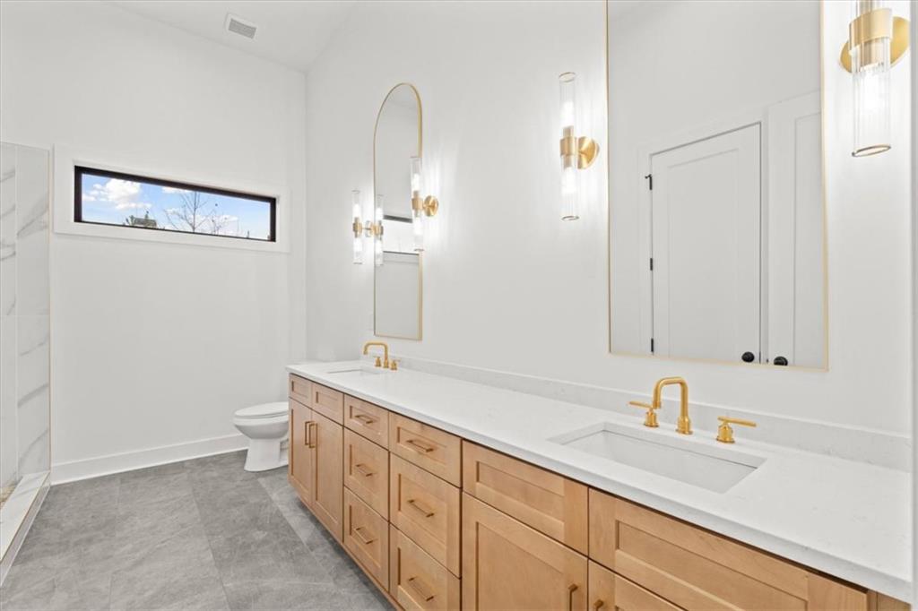 419 Lively Road Waco, GA 30182 - Photo 26 of 48 a spacious bathroom with a double vanity sink a mirror and a