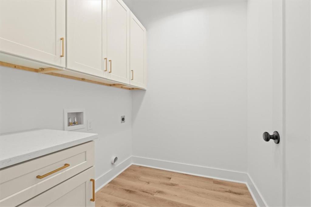 419 Lively Road Waco, GA 30182 - Photo 29 of 48 a view of cabinets and utility room with wooden floor