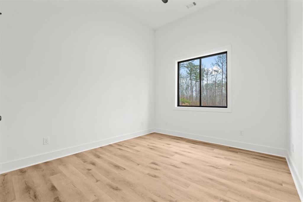 419 Lively Road Waco, GA 30182 - Photo 30 of 48 a view of an empty room with wooden floor and a window