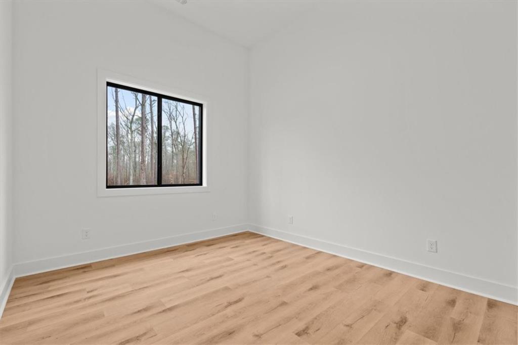 419 Lively Road Waco, GA 30182 - Photo 35 of 48 a view of an empty room with wooden floor and a window