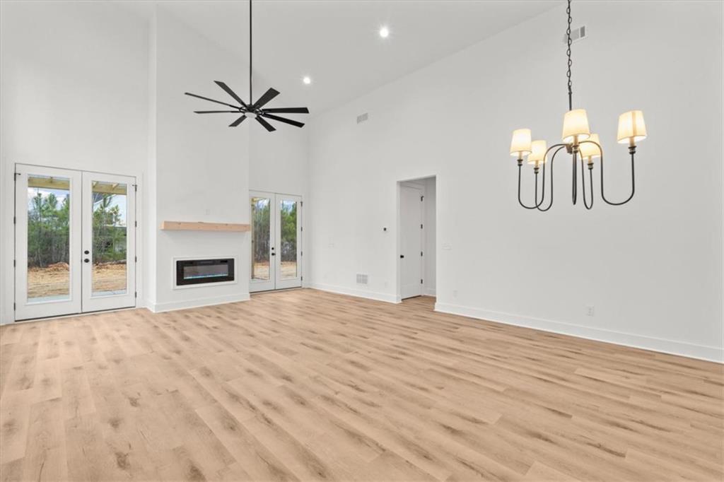 419 Lively Road Waco, GA 30182 - Photo 10 of 48 a view of empty room with wooden floor and ceiling fan