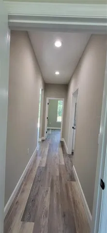 a view of a room with wooden floor