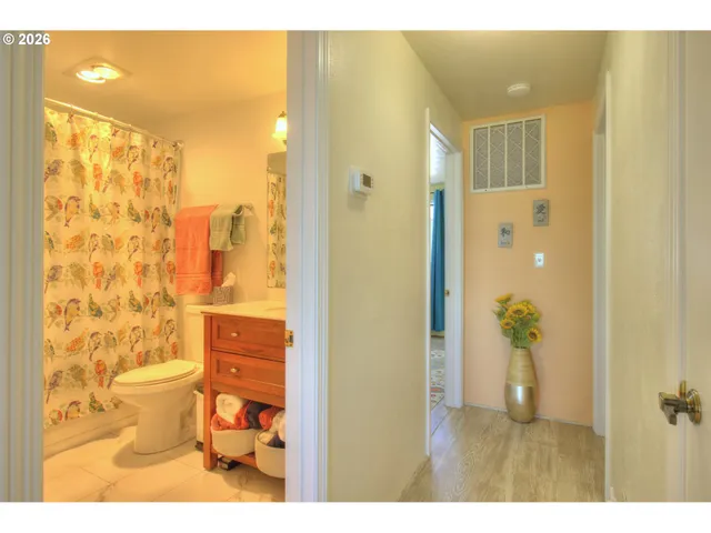 a bathroom with a toilet sink and shower curtain