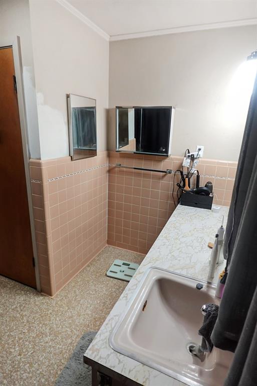 403 West Tarleton Street Stephenville, TX 76401 - Photo 13 of 19 a living room with a couch and a flat screen tv