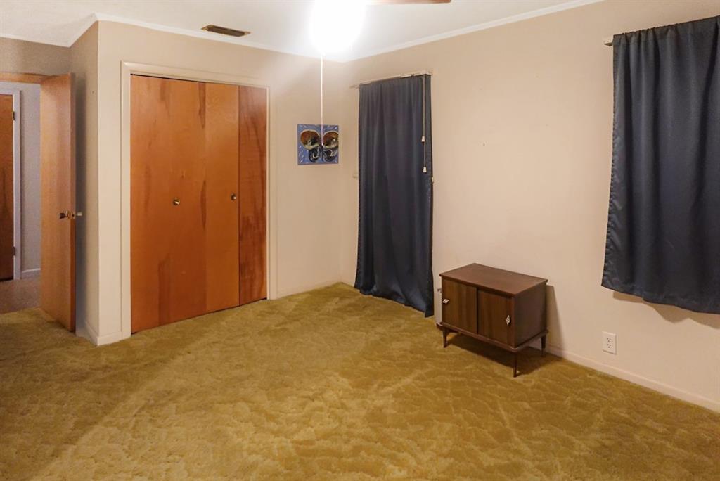 403 West Tarleton Street Stephenville, TX 76401 - Photo 15 of 19 a bed room with a bed and mirror