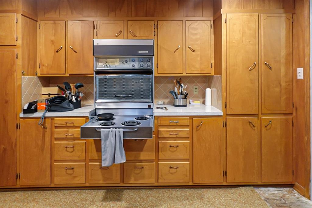 403 West Tarleton Street Stephenville, TX 76401 - Photo 8 of 19 a kitchen with stainless steel appliances granite countertop a sink and cabinets