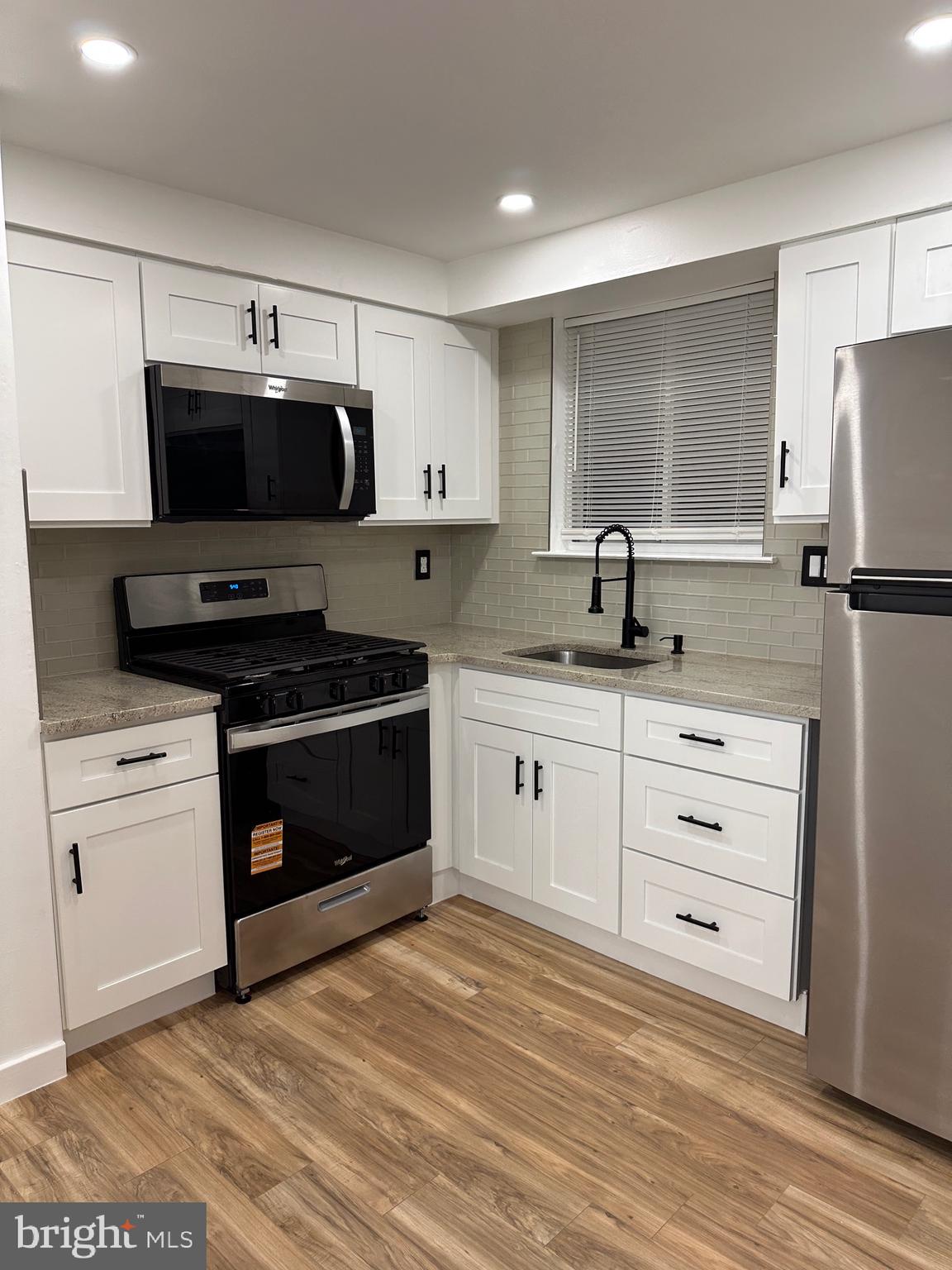 9405 Kirkwood Road Philadelphia, PA 19114 - Photo 13 of 66 a kitchen with a sink stove and refrigerator