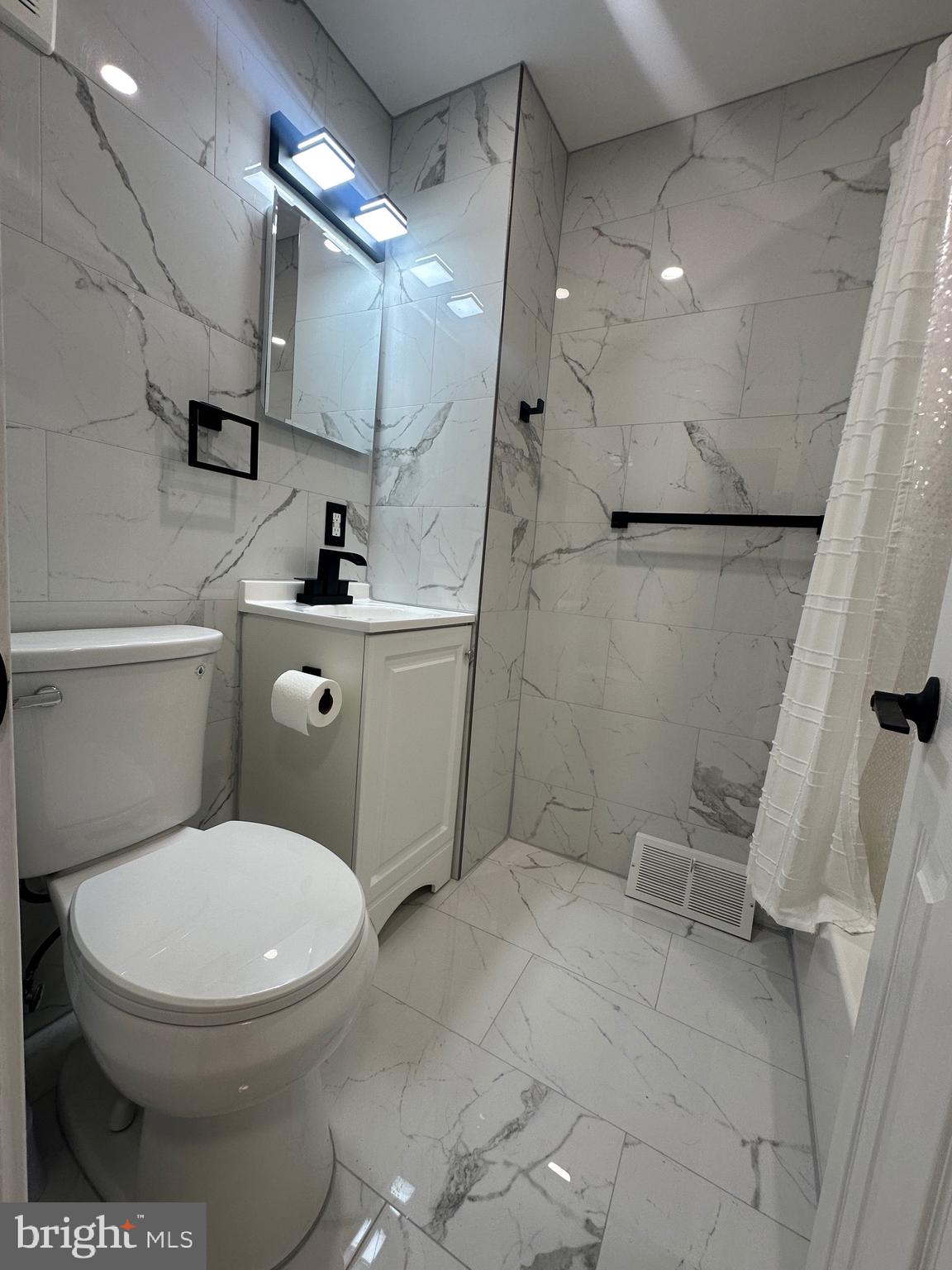 9405 Kirkwood Road Philadelphia, PA 19114 - Photo 18 of 66 a bathroom with a toilet sink and mirror