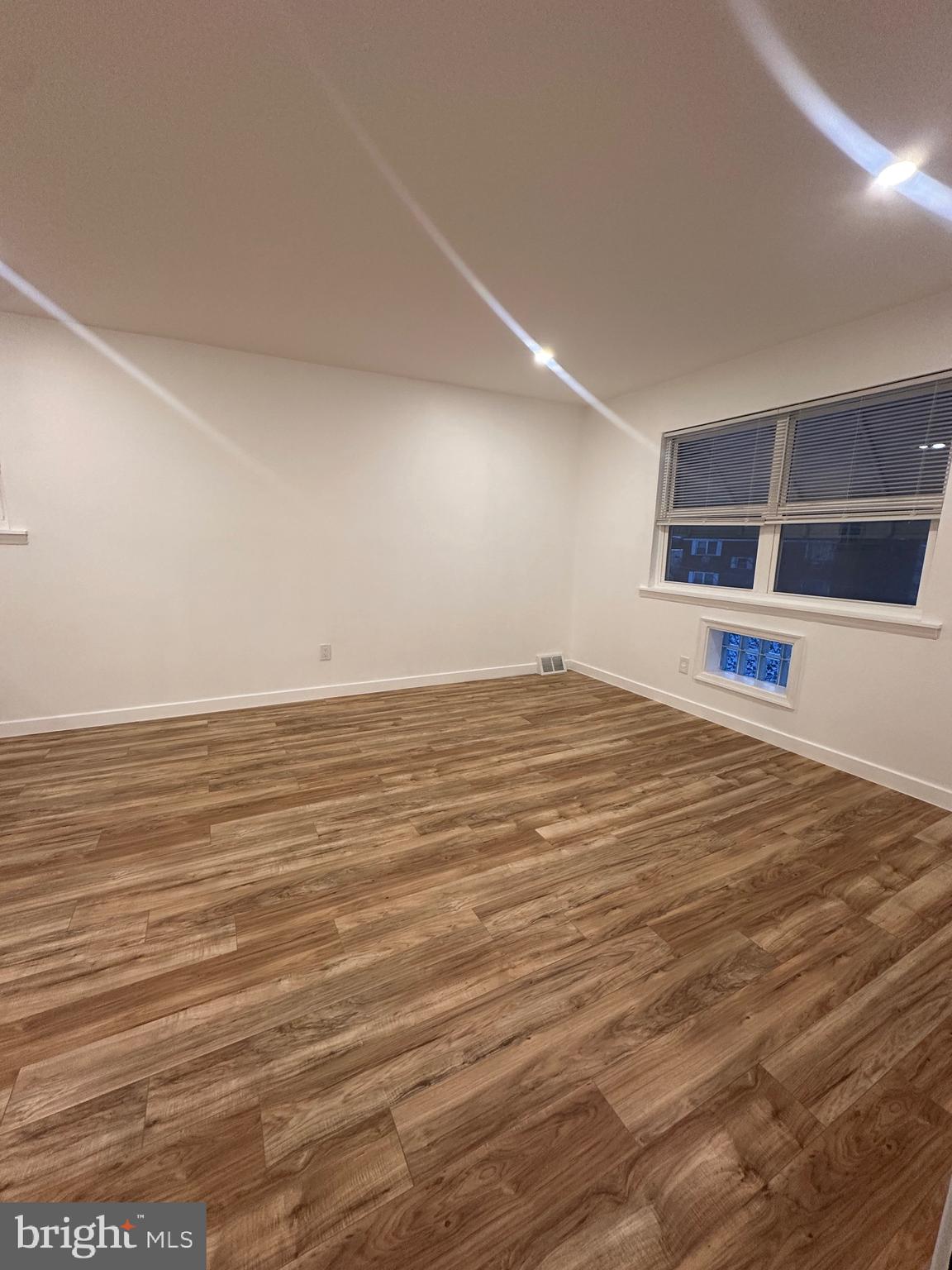 9405 Kirkwood Road Philadelphia, PA 19114 - Photo 34 of 66 an empty room with wooden floor and windows