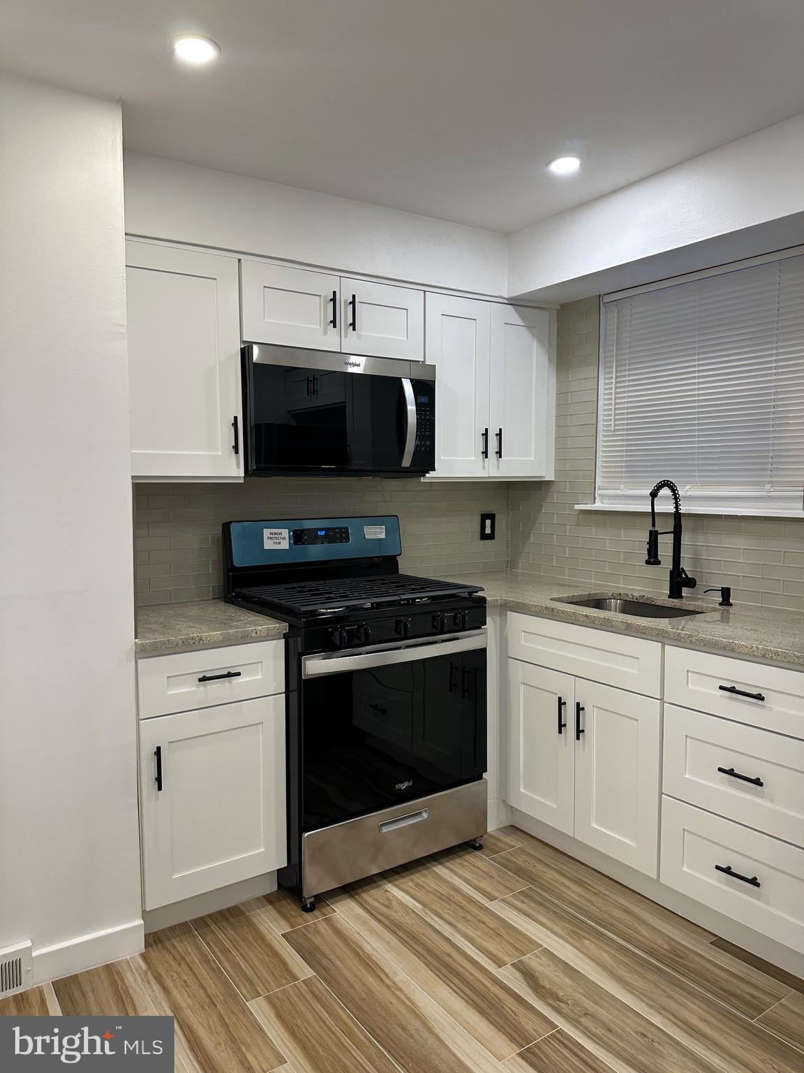 9405 Kirkwood Road Philadelphia, PA 19114 - Photo 37 of 66 a kitchen with stainless steel appliances granite countertop a stove and a sink