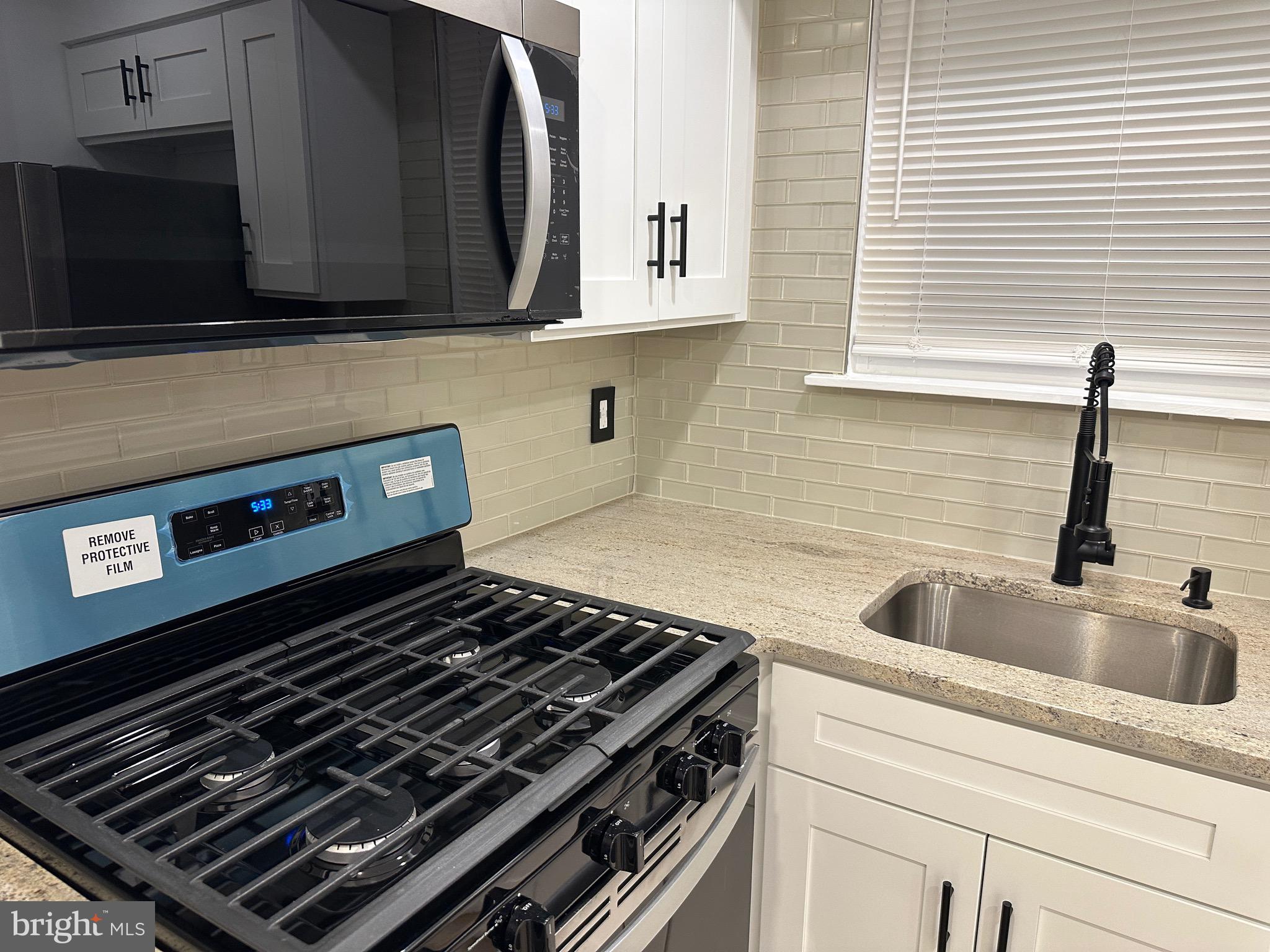 9405 Kirkwood Road Philadelphia, PA 19114 - Photo 38 of 66 a kitchen with a stove and a microwave
