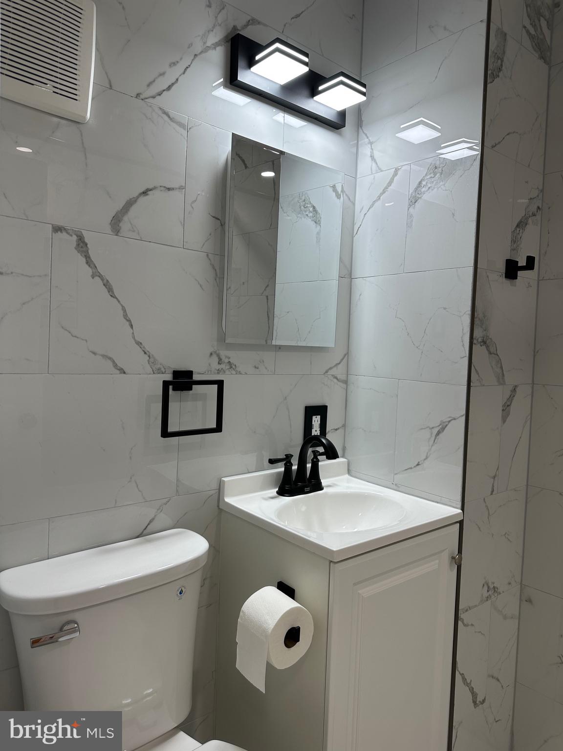 9405 Kirkwood Road Philadelphia, PA 19114 - Photo 42 of 66 a bathroom with a sink a toilet and mirror