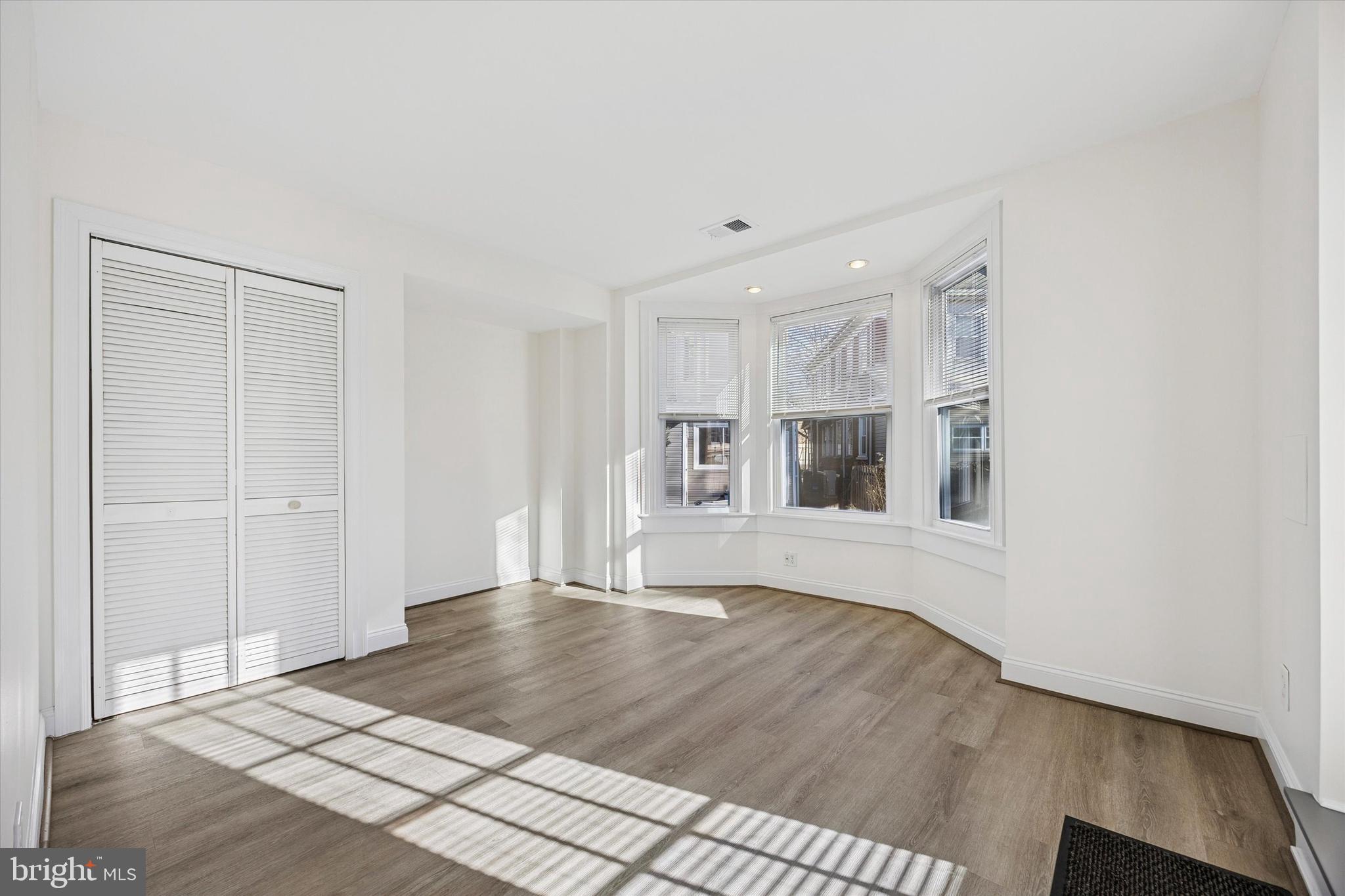 5449 Ridge Avenue, Unit 2 Philadelphia, PA 19128 - Photo 11 of 15 a view of an empty room with wooden floor and a window