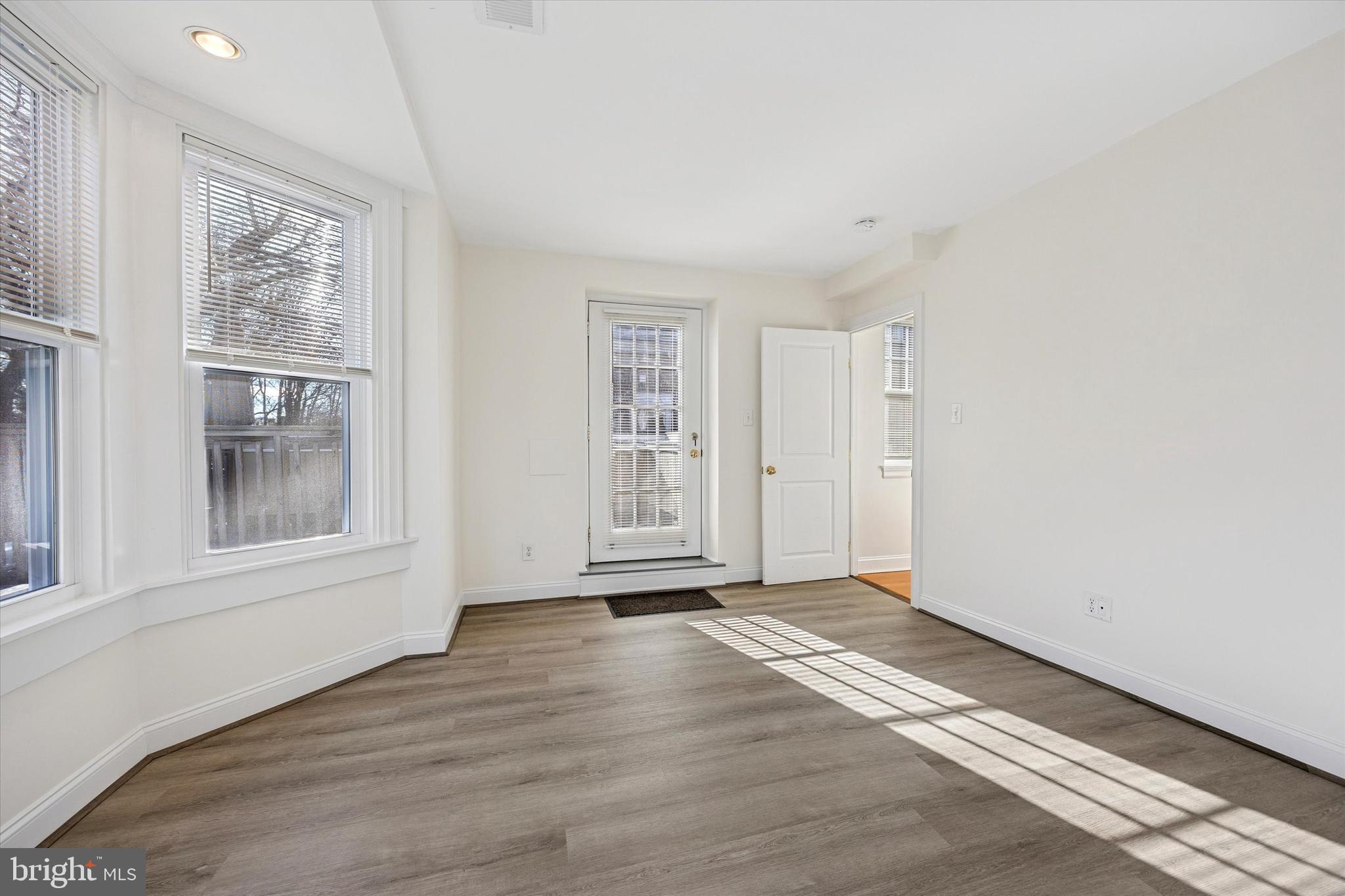 5449 Ridge Avenue, Unit 2 Philadelphia, PA 19128 - Photo 12 of 15 a view of an empty room with wooden floor and a window