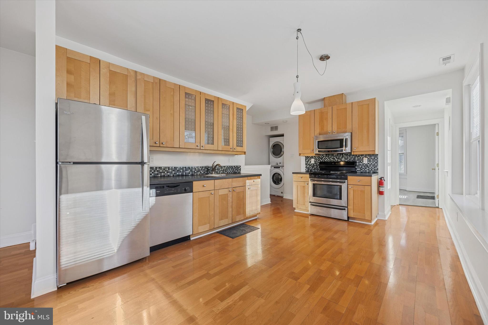 5449 Ridge Avenue, Unit 2 Philadelphia, PA 19128 - Photo 2 of 15 a kitchen with stainless steel appliances a refrigerator and a stove top oven