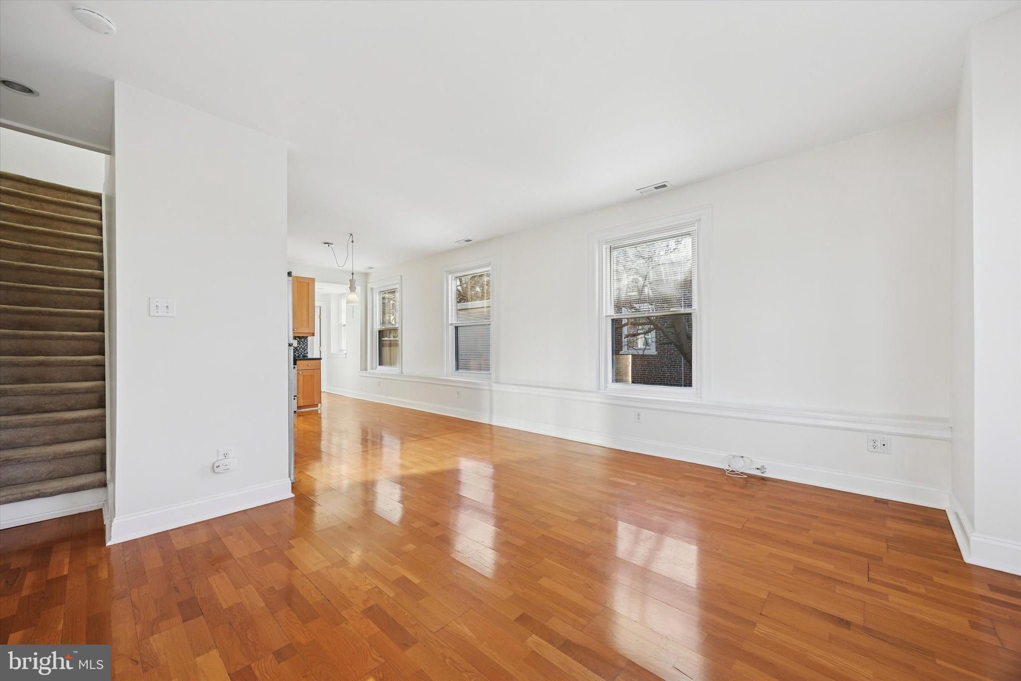 5449 Ridge Avenue, Unit 2 Philadelphia, PA 19128 - Photo 4 of 15 a view of an empty room with wooden floor and a window