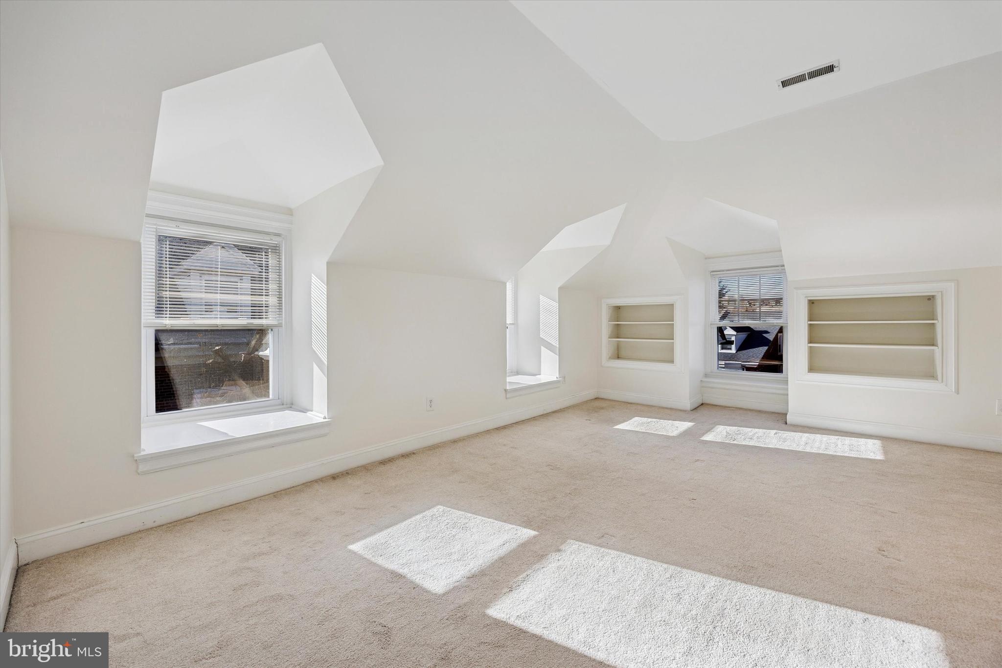 5449 Ridge Avenue, Unit 2 Philadelphia, PA 19128 - Photo 7 of 15 an empty room with a fireplace and wooden floor