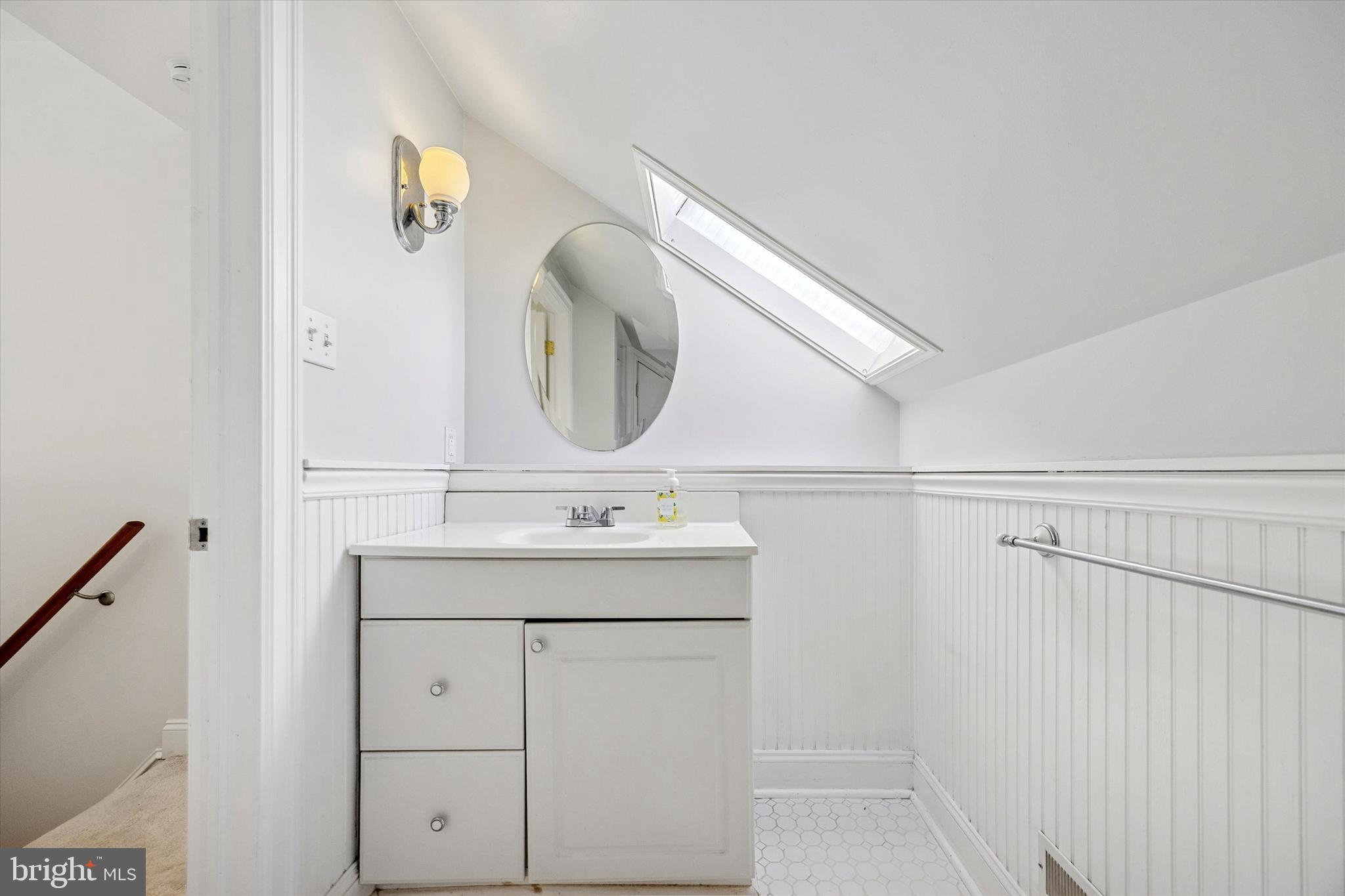 5449 Ridge Avenue, Unit 2 Philadelphia, PA 19128 - Photo 10 of 15 a bathroom with a sink and a mirror