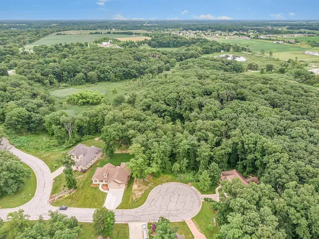 an aerial view of a house with outdoor space and a lake view