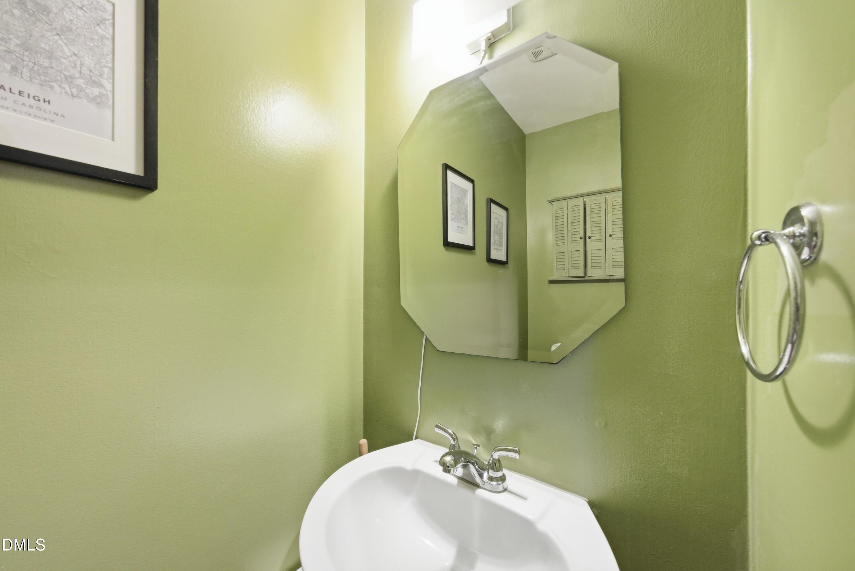 6355 New Market Way Raleigh, NC 27615 - Photo 21 of 30 a bathroom with a sink and mirror