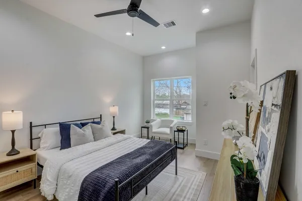 a bedroom with a bed and a potted plant