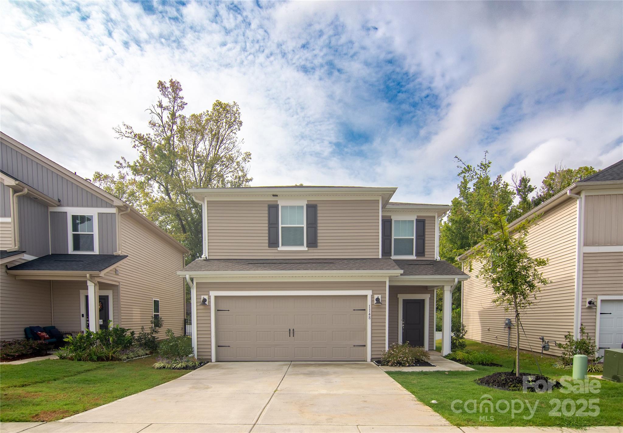 1148 Harland Street, Unit 52 Charlotte, NC 28216 - Photo 1 of 26 a front view of a house with a garden and plants