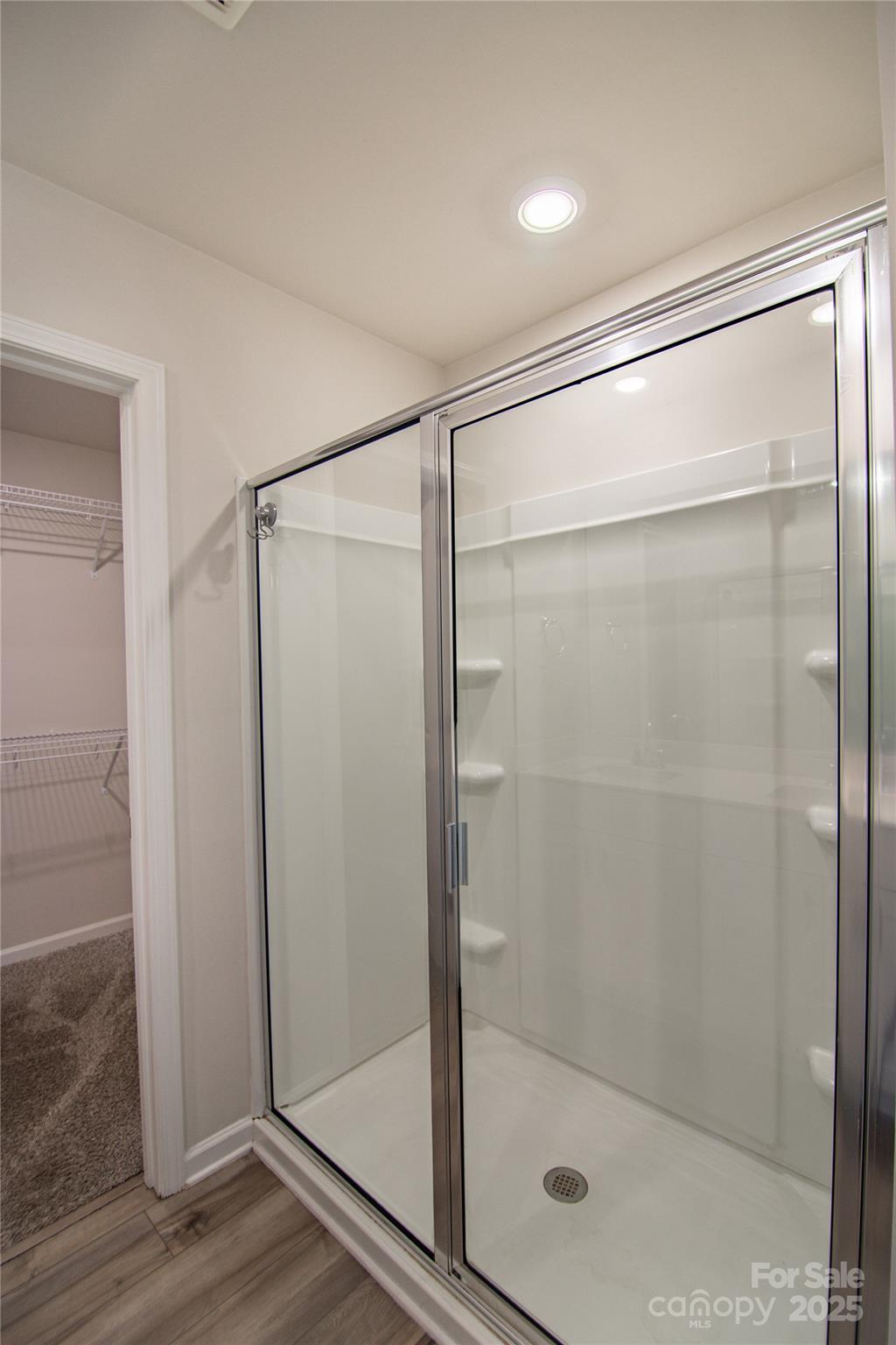 1148 Harland Street, Unit 52 Charlotte, NC 28216 - Photo 14 of 26 a bathroom with a glass shower door