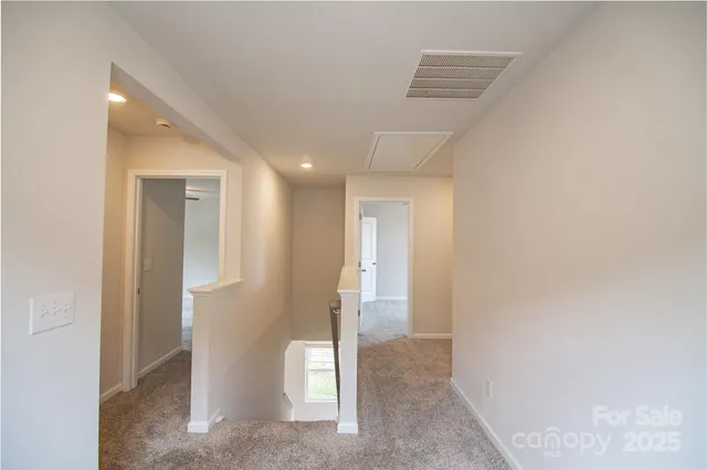 a view of an empty room and wooden floor