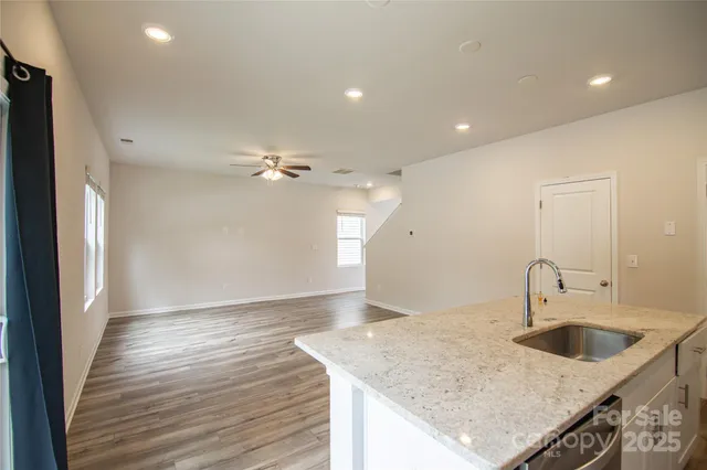 a kitchen with a sink dishwasher and a refrigerator
