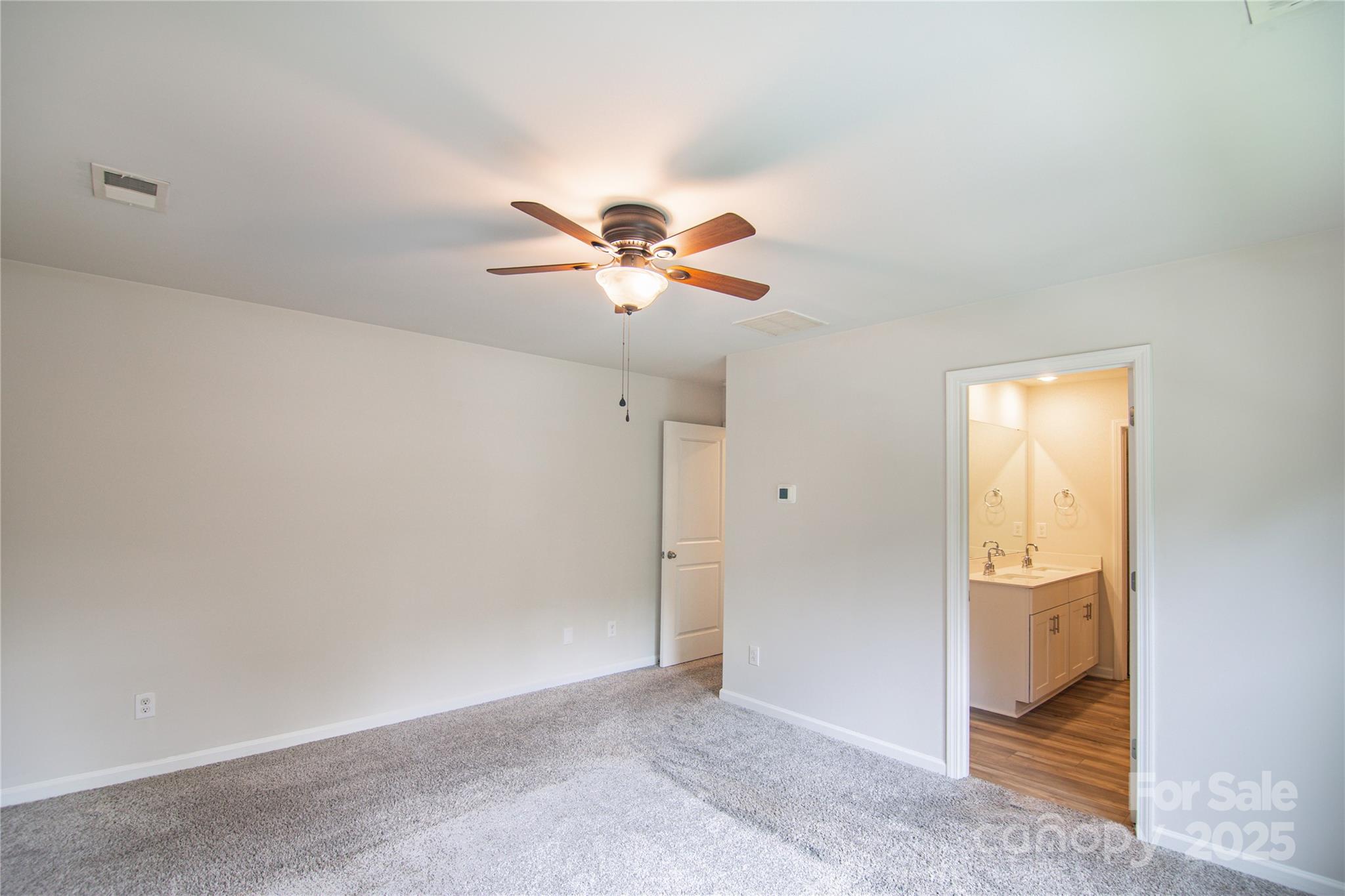 1148 Harland Street, Unit 52 Charlotte, NC 28216 - Photo 10 of 26 an empty room with closet and ceiling fan