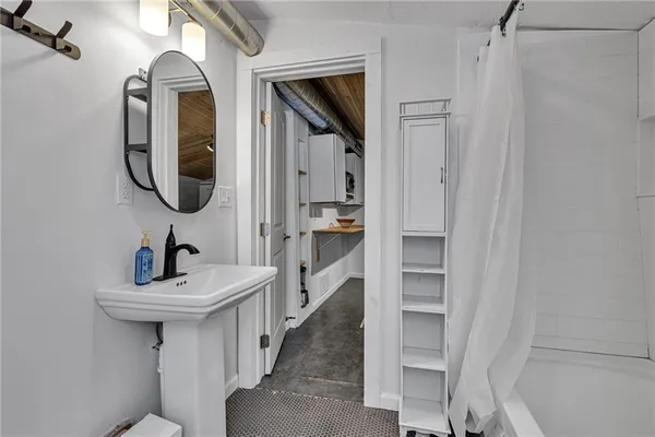 a bathroom with a sink a mirror and a shower