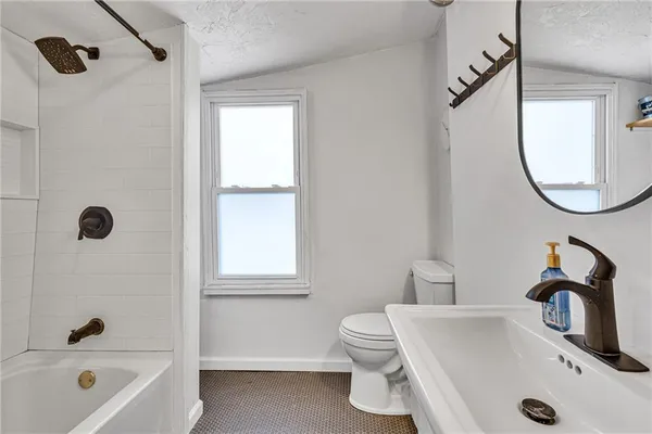 a bathroom with a sink a toilet and a bathtub