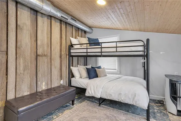 a bedroom with a bed and a mirror