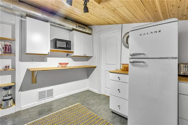 a kitchen with cabinets and stainless steel appliances