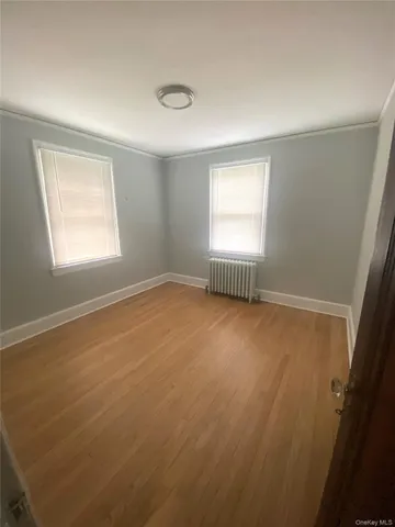 an empty room with a empty space and windows