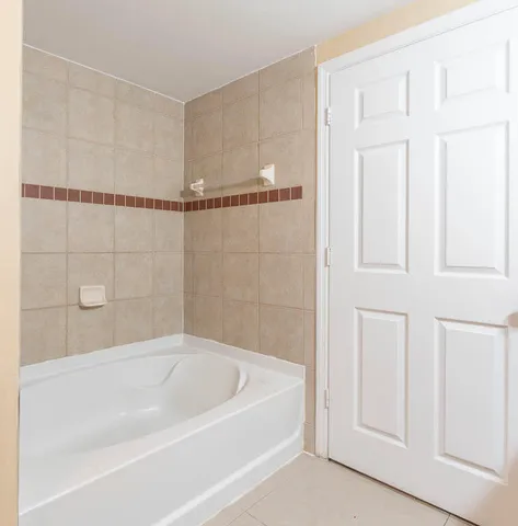 a bathroom with a granite countertop sink and a toilet