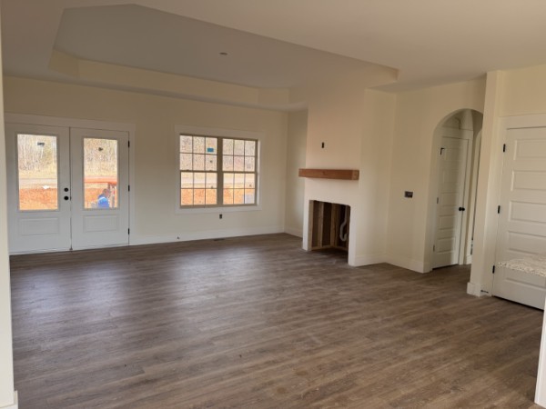 531 Old Hopkinsville Road Cadiz, KY 42211 - Photo 5 of 15 an empty room with wooden floor fireplace and windows