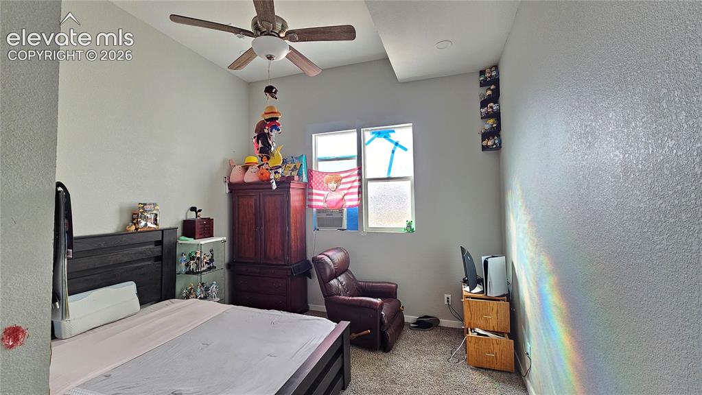 3835 Sengbeil Road Yoder, CO 80864 - Photo 20 of 48 a bedroom with a bed and a chandelier
