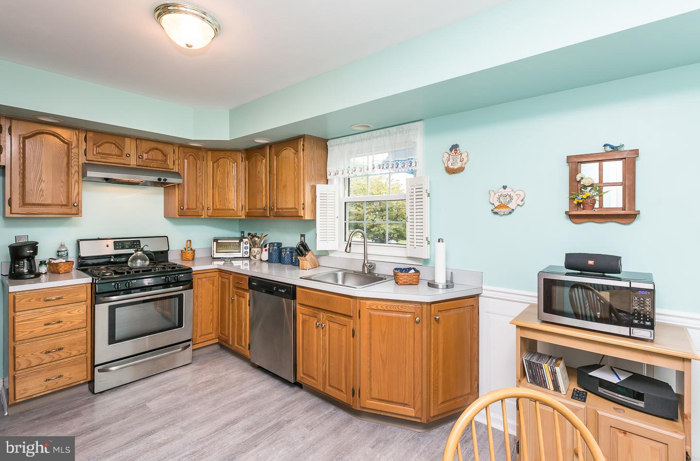 1941 Oak Leaf Lane Holmes, PA 19043 - Photo 11 of 44 a kitchen with stainless steel appliances a sink stove and cabinets