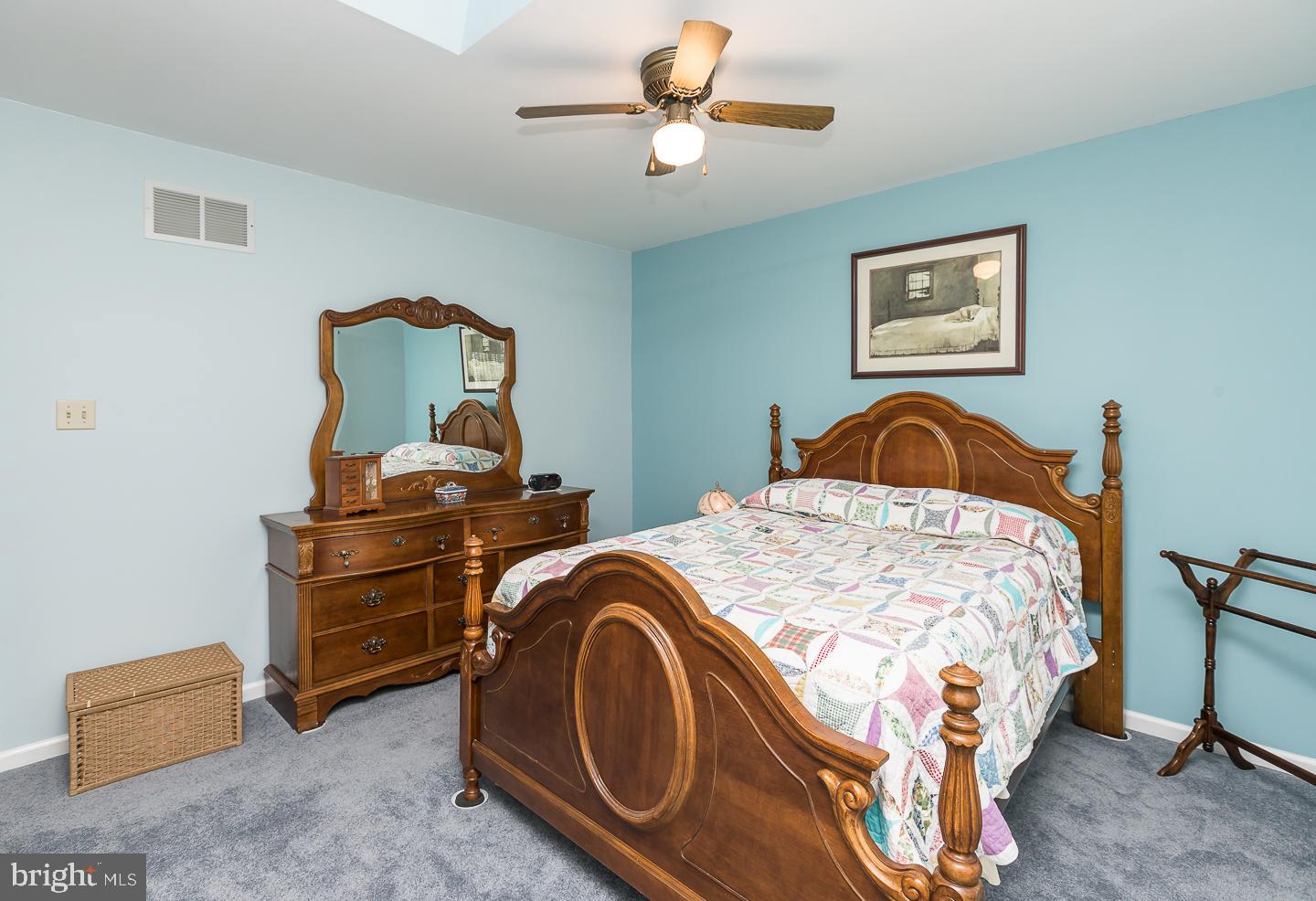 1941 Oak Leaf Lane Holmes, PA 19043 - Photo 16 of 44 a bedroom with a bed and a chandelier